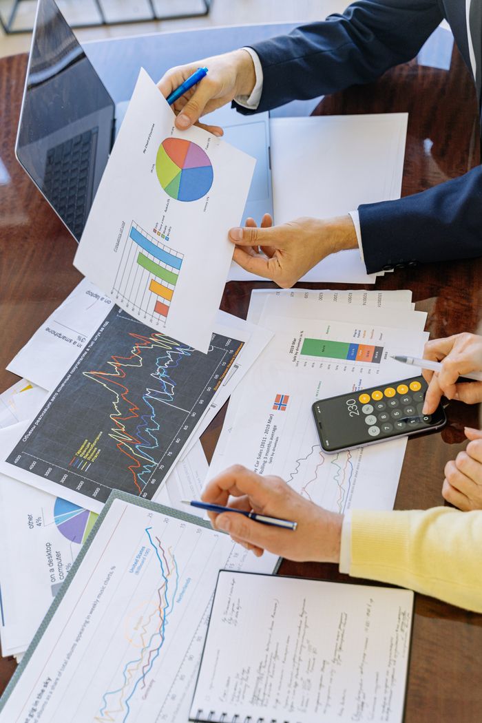 services-01 Business professionals analyzing financial charts and graphs during a meeting.