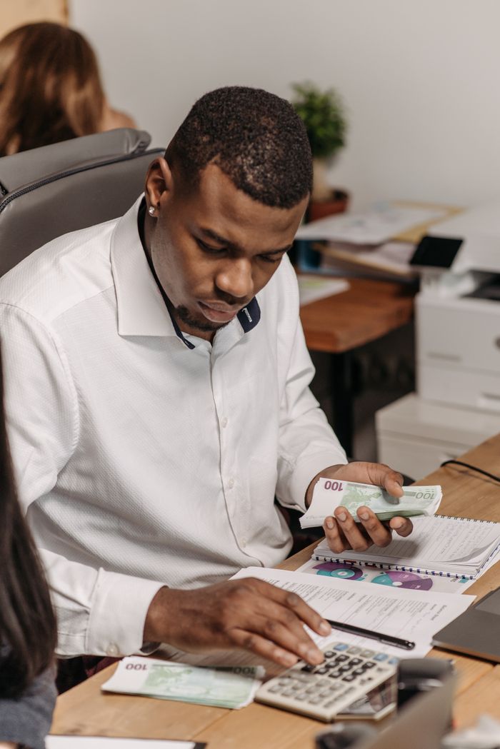 Mastering the First Impression: Your intriguing post title goes here Professional counting money in an office, emphasizing finance and accounting.